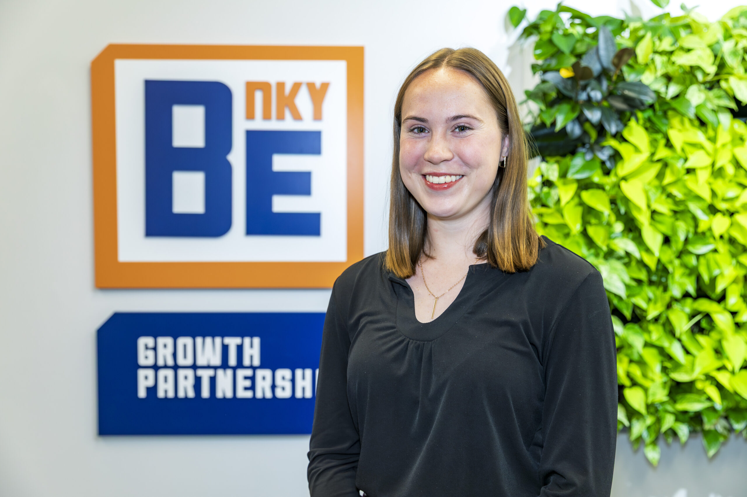 Autumn Strebel standing by BE NKY Growth Partnership sign