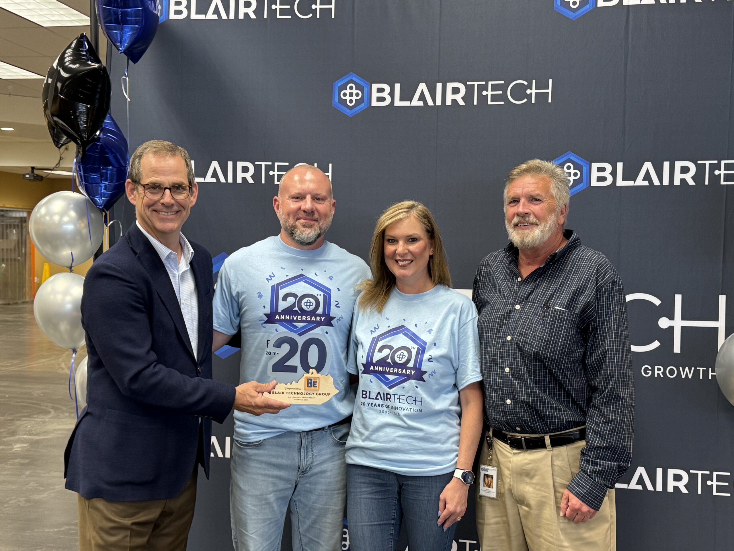 BE NKY CEO Lee Crume – BlairTech CEO Andy Blair – BlairTech Marketing Director Laura Blair – Covington Economic Development Director Tom West BE NKY CEO Lee Crume, BlairTech CEO Andy Blair, BlairTech Marketing Director Laura Blair, and Covington Economic Development Director Tom West post for photo at Blairtech Anniversary celebration