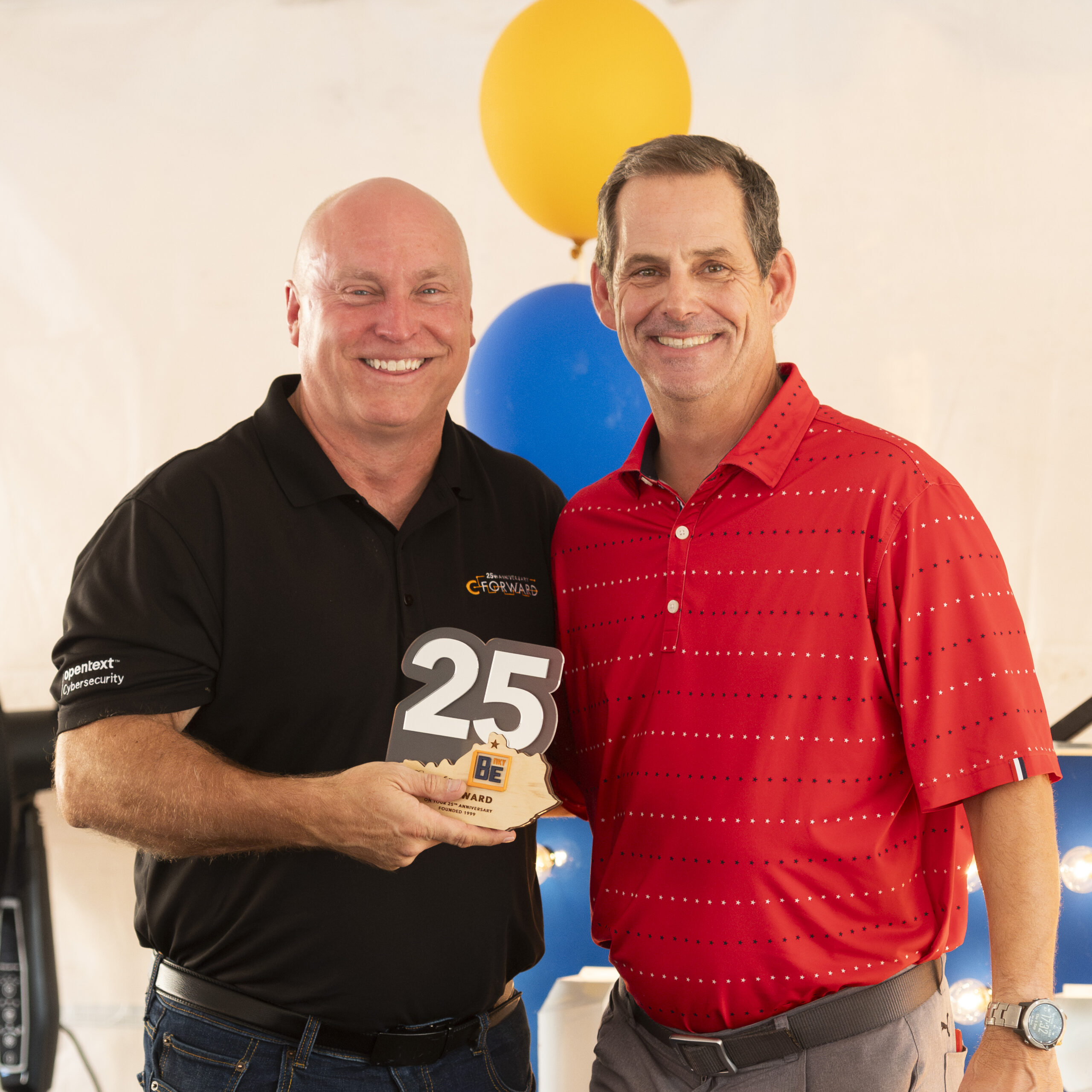 CF25_21 C-Forward Founder & CEO Brent Cooper stands with BE NKY President & CEO Lee Crume while holding 25th anniversary award
