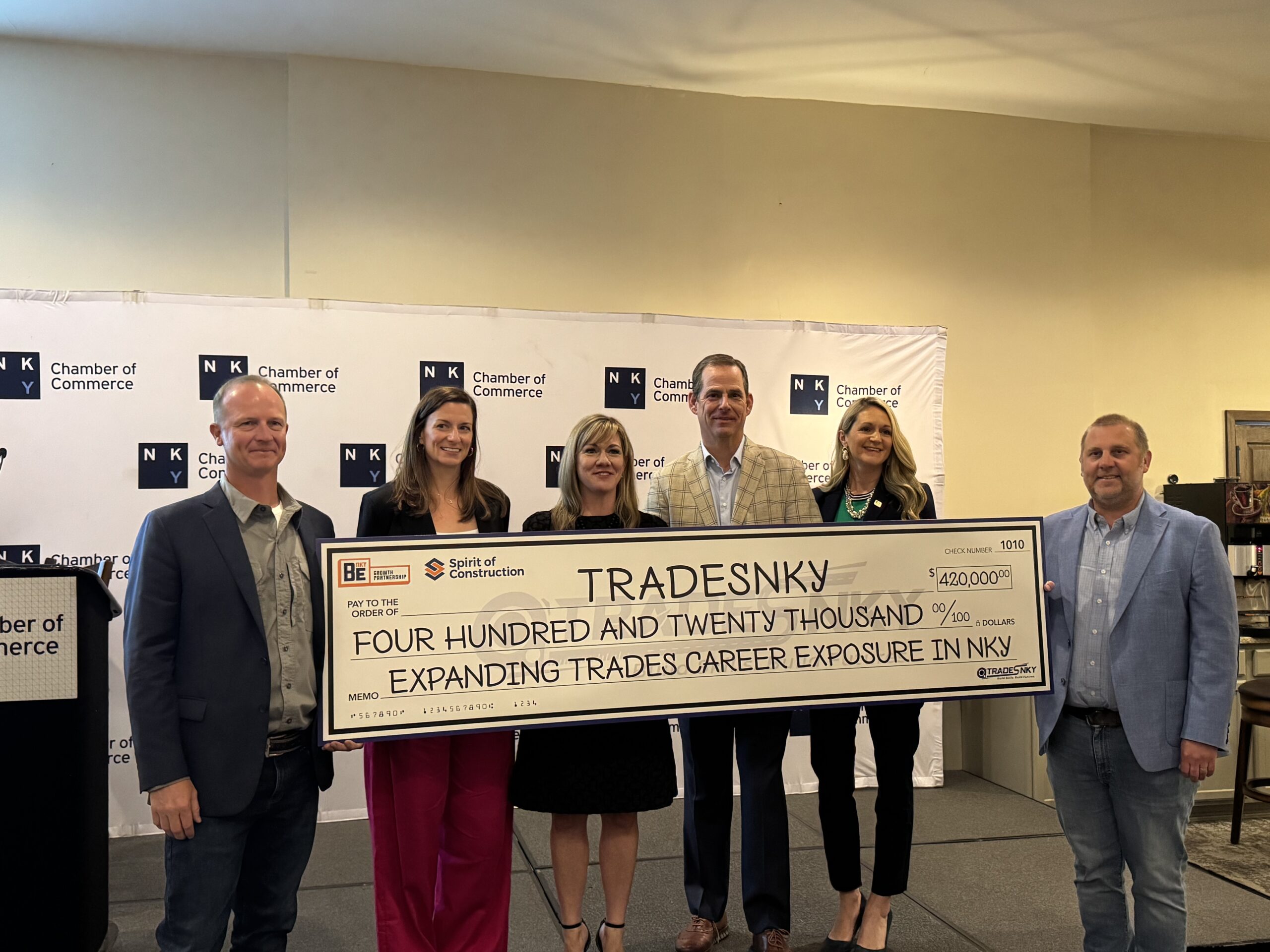 BE NKY presents check to TradesNKY at Eggs 'N Issues.
